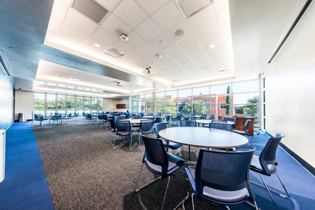 Large open commercial workplace with flexible gathering tables