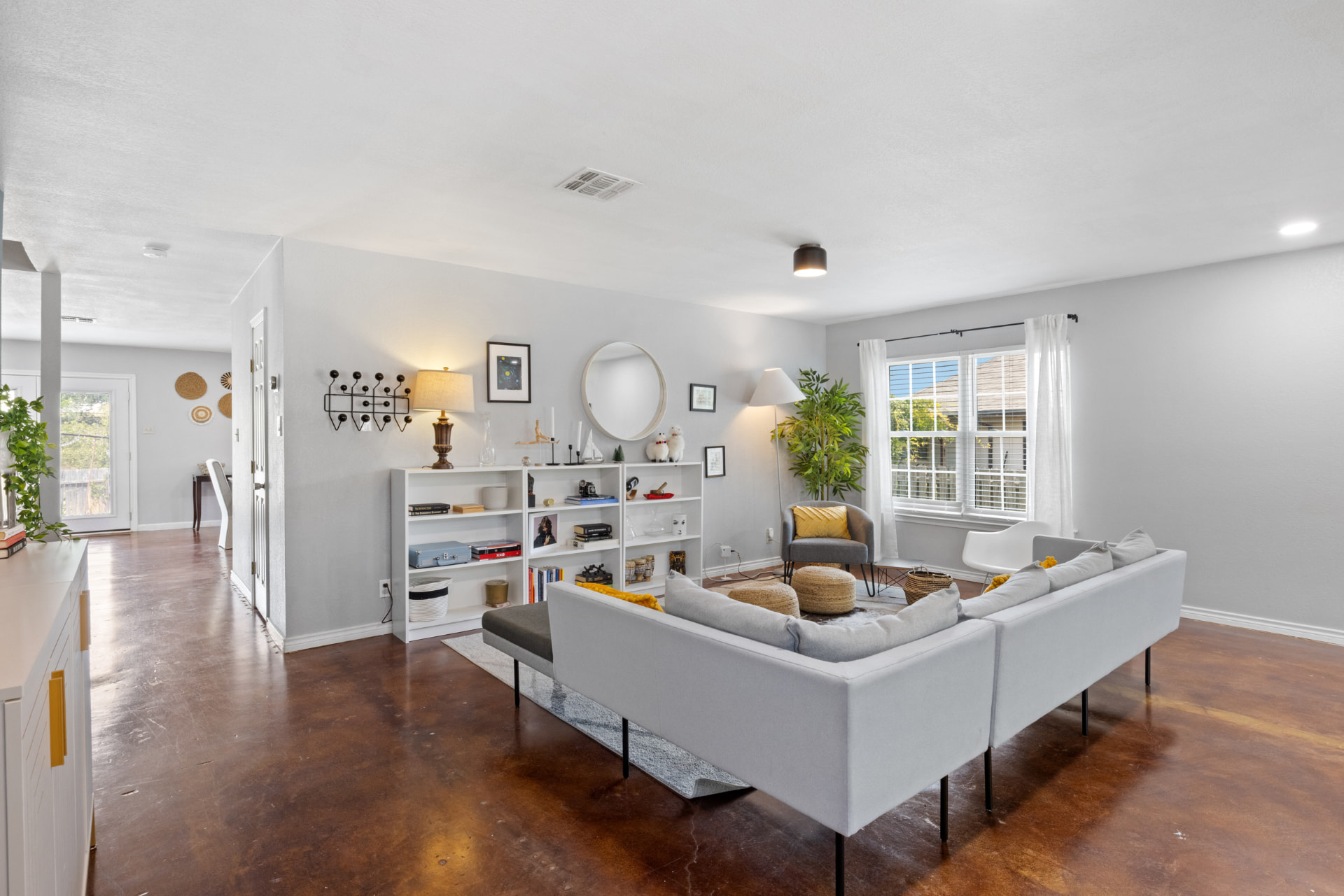 Bright Austin rental living room with bookshelf and large windows