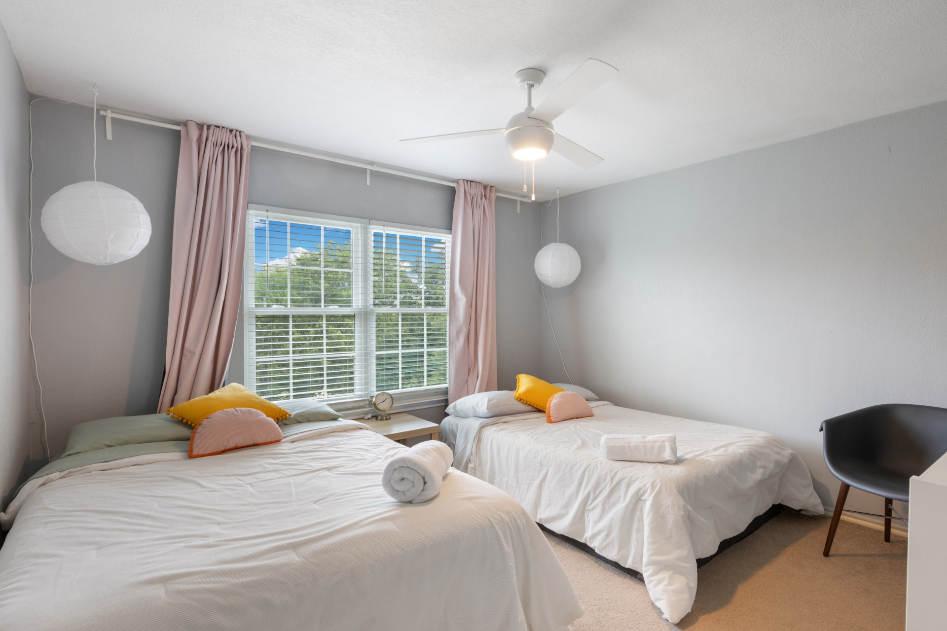 Twin guest room with pink curtains in the Austin rental